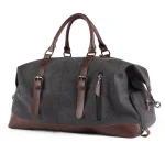 Grand sac de voyage vintage en toile et cuir gris Grand sac de voyage vintage en toile et cuir, pratique et résistant de couleur gris avec fond blanc