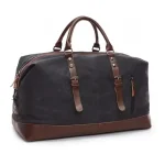 Grand sac de voyage vintage en toile et cuir noir Grand sac de voyage vintage en toile et cuir, pratique et résistant de couleur noir