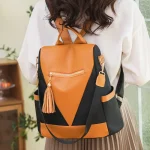 Petit sac à dos tendance anti-volorange et noir porté dans le dos Petit sac à dos tendance anti-volorange et noir porté dans le dos